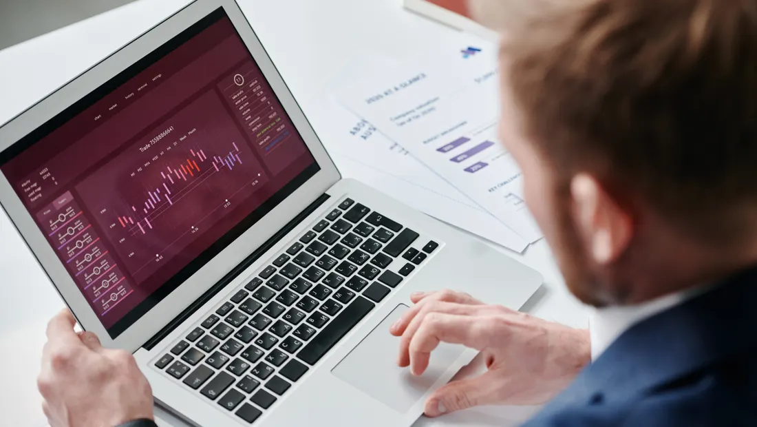 A marketer reviewing an analytics dashboard on a laptop