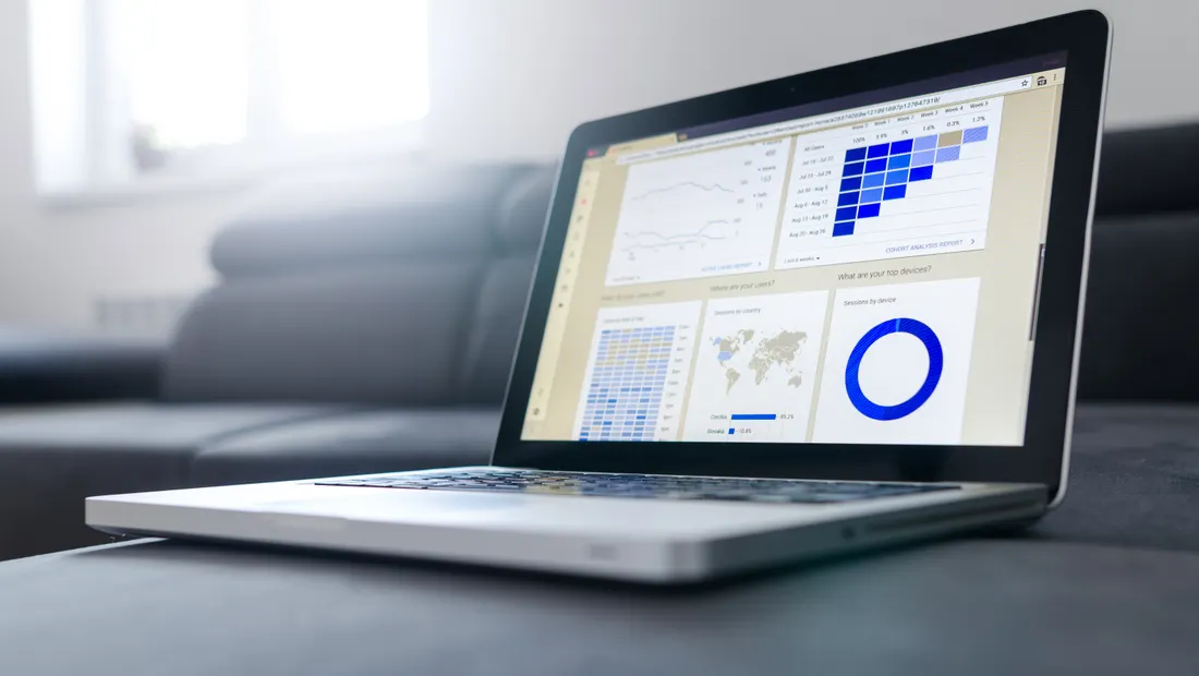 A laptop showing marketing charts and performance graphs