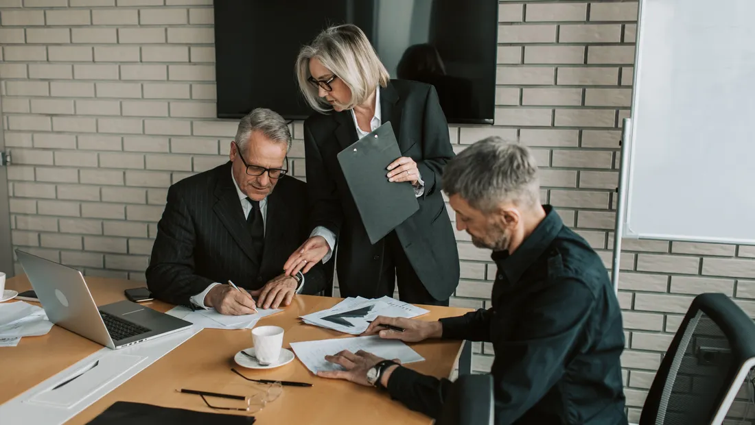 Business leaders reviewing a marketing plan across the table